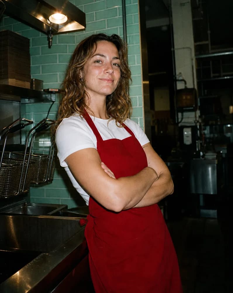 Jess leaning on the counter beside the fry baskets
