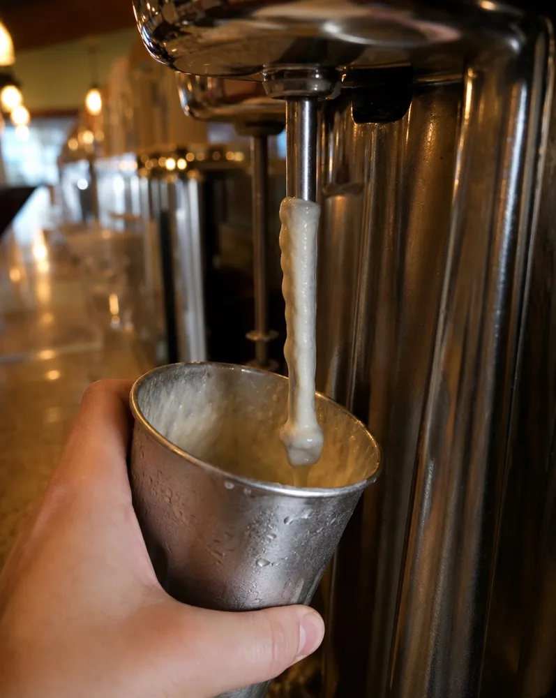A shake cup coming off the spindle mixer