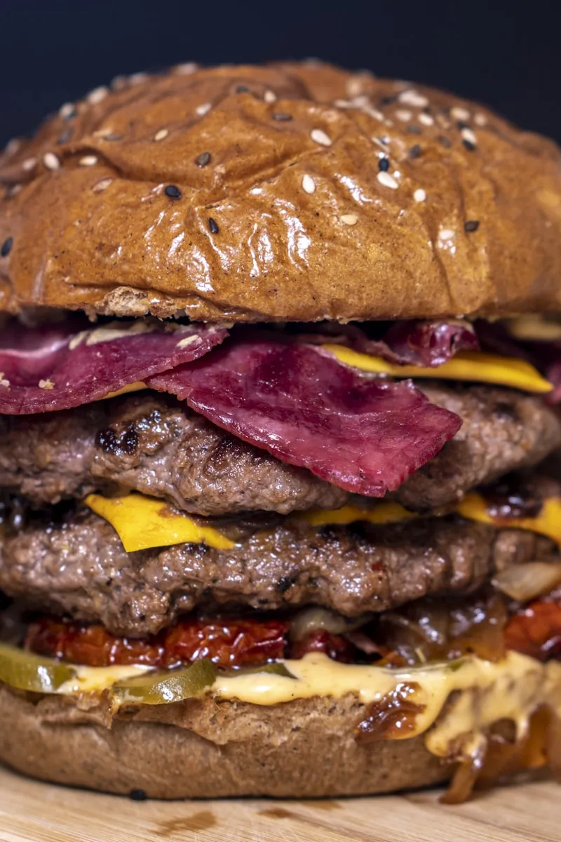 Tall burger stacked with bacon and double patties