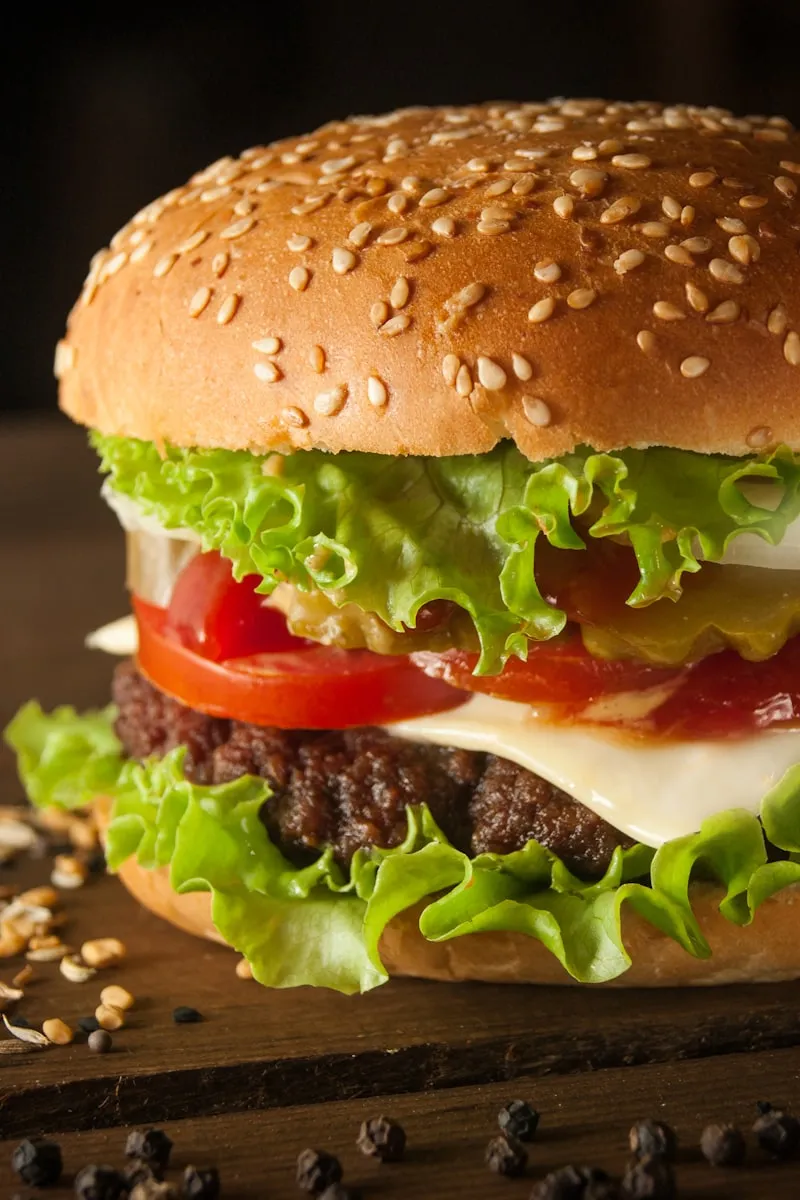 Cheeseburger with lettuce and tomato on a sesame bun