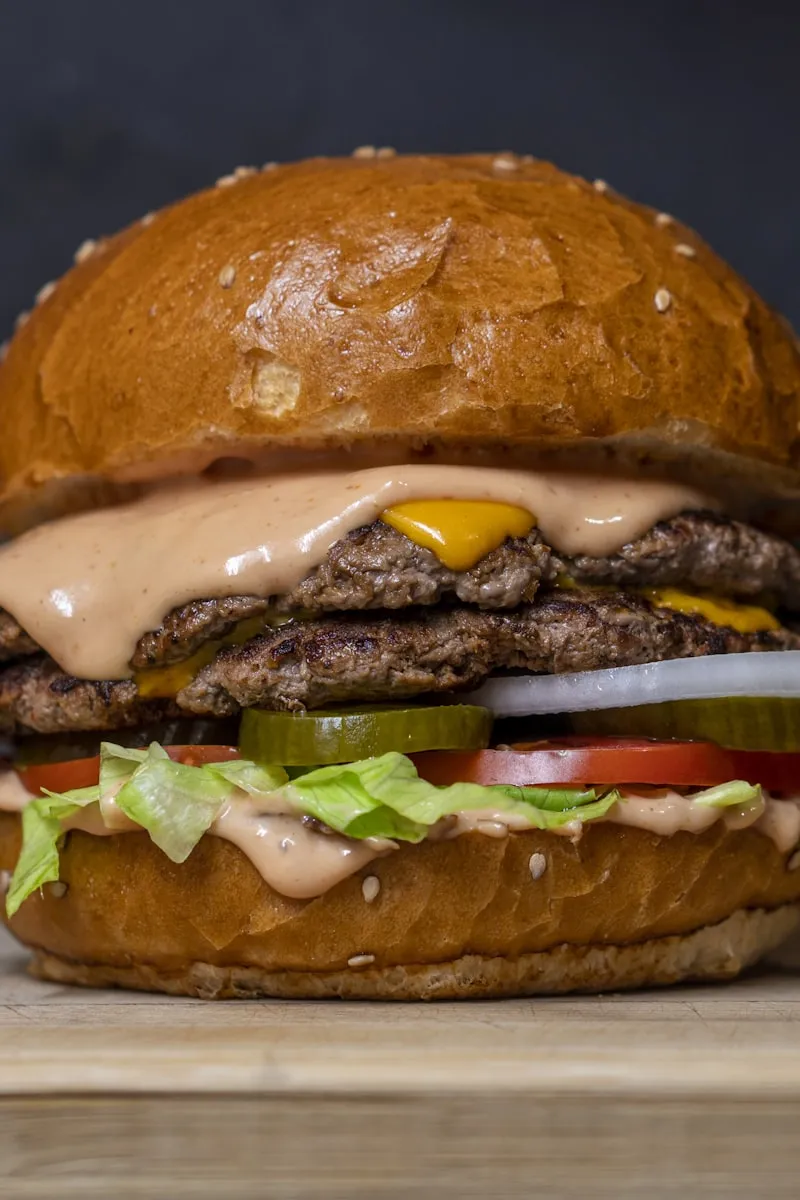 Smash burger with house sauce dripping over the patties